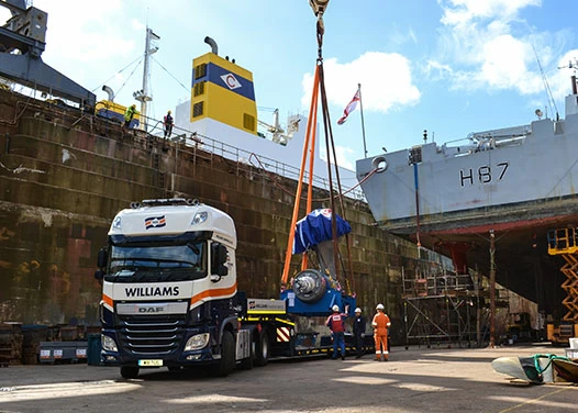 Low loader transporting heavy goods