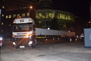 truck transporting beams during the night 