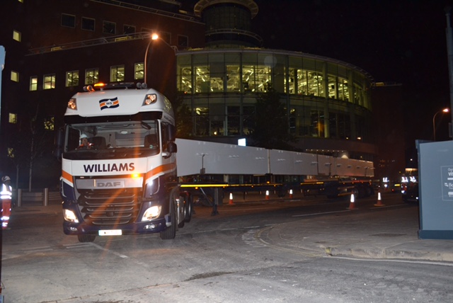 truck transporting beams in the dark