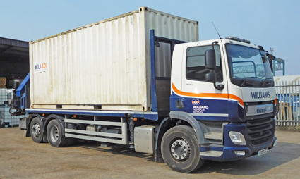 White shipping container on the back of a lorry