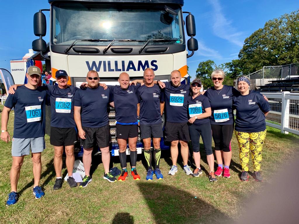 The Williams Shipping New Forest Marathon team in front of a Williams Shipping lorry