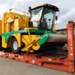 Harvesting machine on flat rack