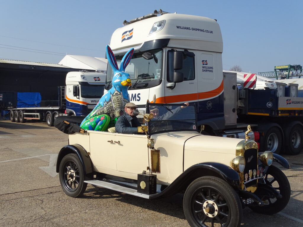 Vintage car in front of Williams Shipping truck